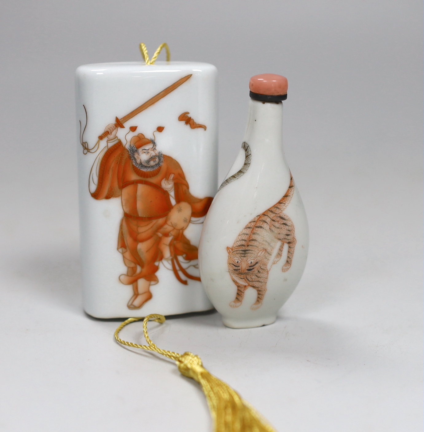 A Chinese famille rose porcelain two part case, painted with figures and an erotic scene, together with a Chinese porcelain snuff bottle enamel painted with a tiger, tallest 9cm high (2)